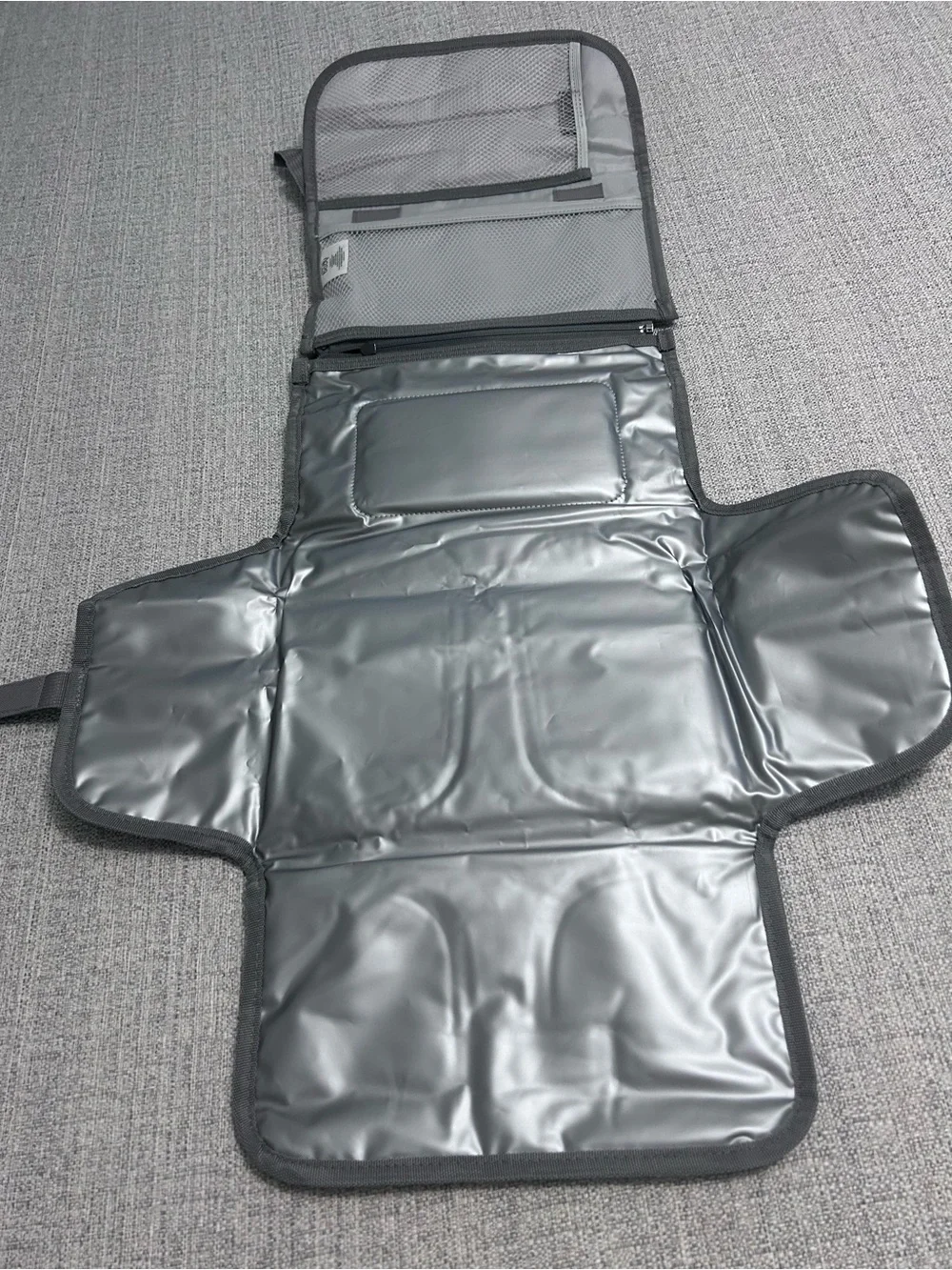 Grey Foldable Portable Changing Pad for Baby with Secure Buckle.